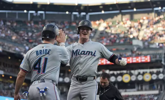 Miami Marlins' Griffin Conine, right, celebrates with Jonah Bride after hitting a two-run home run during the second inning of a baseball game against the San Francisco Giants, Saturday, Aug. 31, 2024, in San Francisco. (AP Photo/Godofredo A. Vásquez)