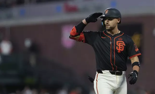 San Francisco Giants' Michael Conforto reacts after hitting a single during the sixth inning of a baseball game against the Miami Marlins, Saturday, Aug. 31, 2024, in San Francisco. (AP Photo/Godofredo A. Vásquez)