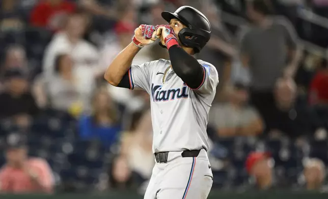 Miami Marlins' Otto Lopez celebrates after his home run during the fourth inning of a baseball game against the Washington Nationals, Friday, Sept. 13, 2024, in Washington. (AP Photo/Nick Wass)