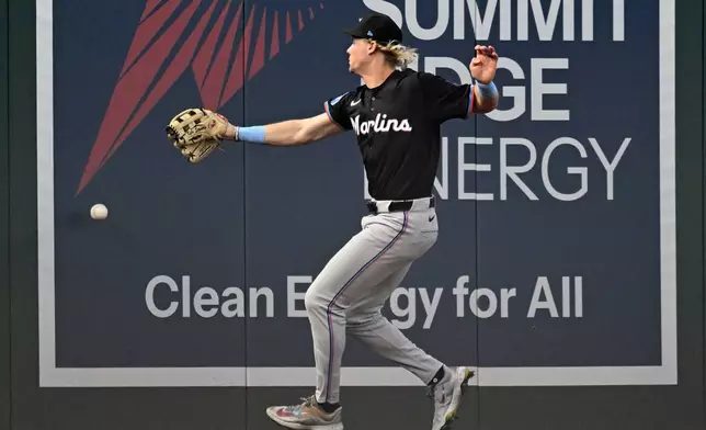 Miami Marlins left fielder Kyle Stowers chases down a two-run RBI double by Washington Nationals' Jose Tena during the first inning of a baseball game, Thursday, Sept. 12, 2024, in Washington. (AP Photo/John McDonnell)