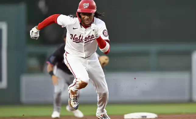 Washington Nationals' CJ Abrams steals third base during the first inning of a baseball game against the Miami Marlins, Thursday, Sept. 12, 2024, in Washington. (AP Photo/John McDonnell)