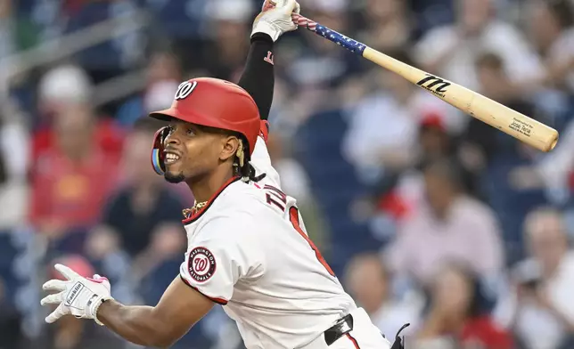 Washington Nationals' Jose Tena watches his two-run RBI double go to left field during the first inning of a baseball game against the Miami Marlins, Thursday, Sept. 12, 2024, in Washington. (AP Photo/John McDonnell)