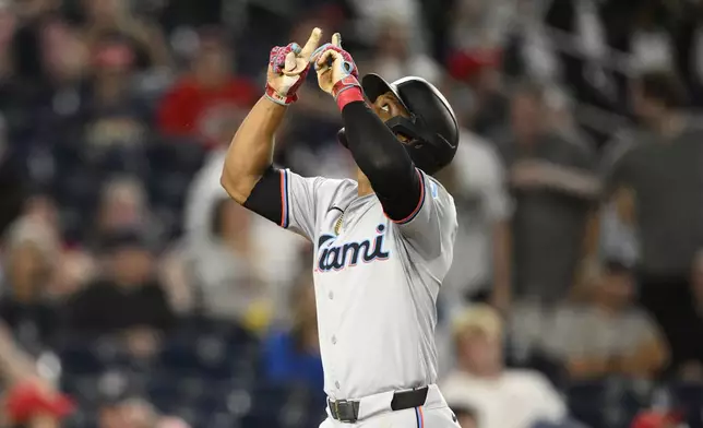 Miami Marlins' Otto Lopez celebrates after his home run during the fourth inning of a baseball game against the Washington Nationals, Friday, Sept. 13, 2024, in Washington. (AP Photo/Nick Wass)