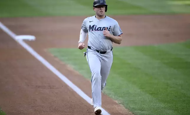 Miami Marlins' Jonah Bride runs towards home to score a run on a single by Otto Lopez during the second inning of a baseball game against the Washington Nationals, Saturday, Sept. 14, 2024, in Washington. (AP Photo/Nick Wass)