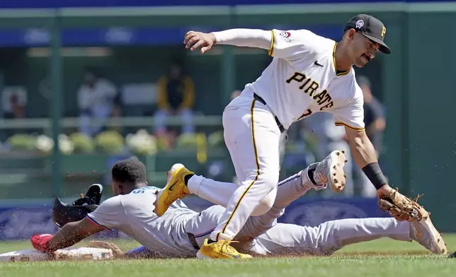 Miami Marlins' Jesus Sanchez, left, steals second base ahead of the tag by Pittsburgh Pirates second baseman Nick Gonzales, right, during the fifth inning of a baseball game Wednesday, Sept. 11, 2024, in Pittsburgh. (AP Photo/Matt Freed)