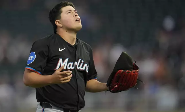 Miami Marlins pitcher Valente Bellozo looks skyward as he walks back to the dugout after the bottom of the first inning of a baseball game against the Minnesota Twins, Thursday, Sept. 26, 2024, in Minneapolis. (AP Photo/Abbie Parr)