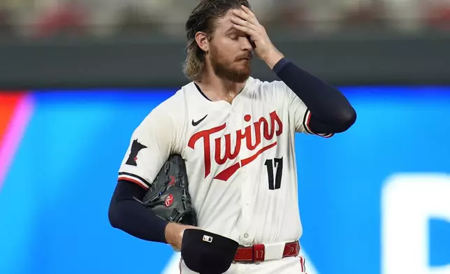 Minnesota Twins starting pitcher Bailey Ober (17) reacts as pitching coach Pete Maki comes to the mound during the first inning of a baseball game against the Miami Marlins, Tuesday, Sept. 24, 2024, in Minneapolis. (AP Photo/Abbie Parr)