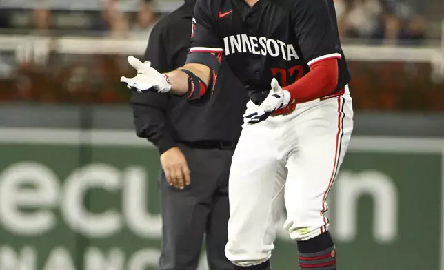 Minnesota Twins' Brooks Lee celebrates after hitting a double against Miami Marlins pitcher Michael Petersen during the seventh inning of a baseball game, Wednesday, Sept. 25, 2024, in Minneapolis. The Twins won 8-3. (AP Photo/Craig Lassig)