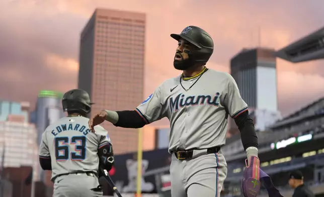 Miami Marlins' Derek Hill celebrates after scoring off an RBI-single by Nick Fortes during the second inning of a baseball game against the Minnesota Twins, Tuesday, Sept. 24, 2024, in Minneapolis. (AP Photo/Abbie Parr)