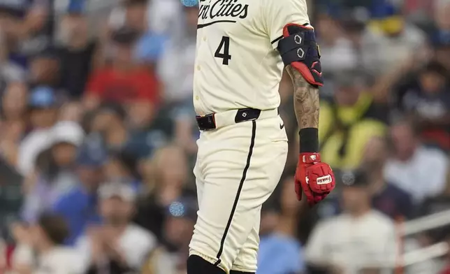 Minnesota Twins' Carlos Correa gestures skyward after hitting a single during the first inning of a baseball game against the Miami Marlins, Thursday, Sept. 26, 2024, in Minneapolis. (AP Photo/Abbie Parr)