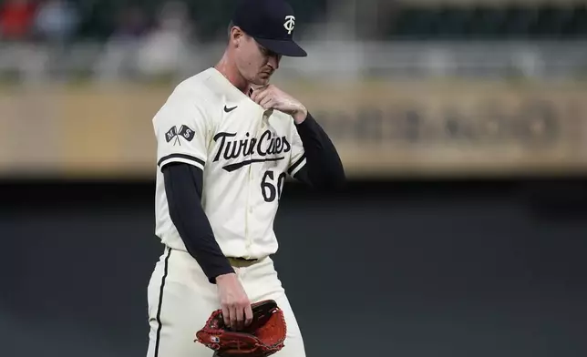 Minnesota Twins relief pitcher Scott Blewett (60) walks back to the dugout after being pulled from the game during the 13th inning of a baseball game against the Miami Marlins, Thursday, Sept. 26, 2024, in Minneapolis. (AP Photo/Abbie Parr)