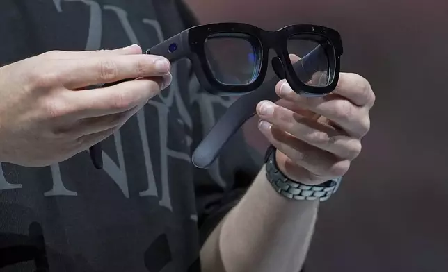 Mark Zuckerberg holds a pair of Orion AR glasses during the Meta Connect conference Wednesday, Sept. 25, 2024, in Menlo Park, Calif. (AP Photo/Godofredo A. Vásquez)