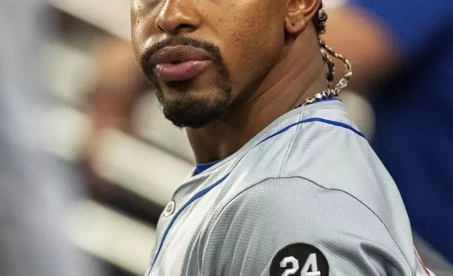 New York Mets shortstop Francisco Lindor sits in the dugout during the third inning of a baseball game against the Atlanta Braves, Tuesday, Sept. 24, 2024, in Atlanta. (AP Photo/Jason Allen)