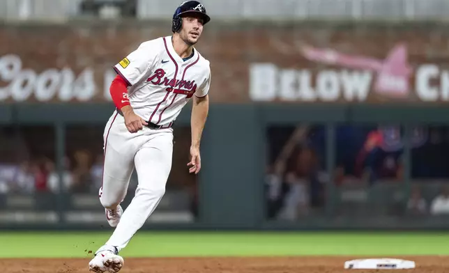 Atlanta Braves' Matt Olson rounds second base after Ramón Laureano (18) hit a line drive to right field in the third inning of a baseball game against the New York Mets, Tuesday, Sept. 24, 2024, in Atlanta. (AP Photo/Jason Allen)