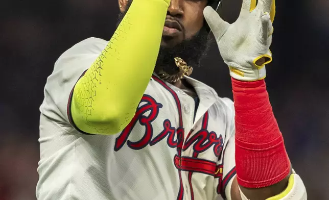 Atlanta Braves' Marcell Ozuna celebrates on the way to first base after hitting a home run in the fifth inning of a baseball game against the New York Mets, Tuesday, Sept. 24, 2024, in Atlanta. (AP Photo/Jason Allen)