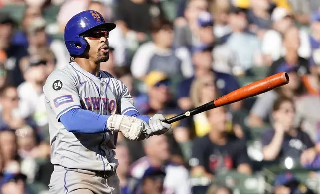 New York Mets' Francisco Lindor watches his solo home run during the sixth inning of a baseball game against the Milwaukee Brewers, Sunday, Sept. 29, 2024, in Milwaukee. (AP Photo/Aaron Gash)