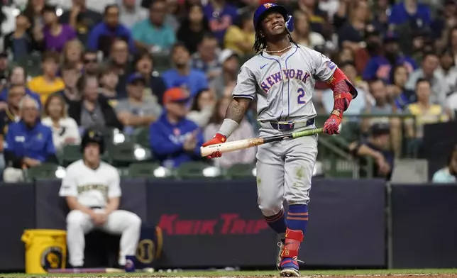 New York Mets' Luisangel Acuña reacts after striking out during the third inning of a baseball game against the Milwaukee Brewers, Saturday, Sept. 28, 2024, in Milwaukee. (AP Photo/Aaron Gash)