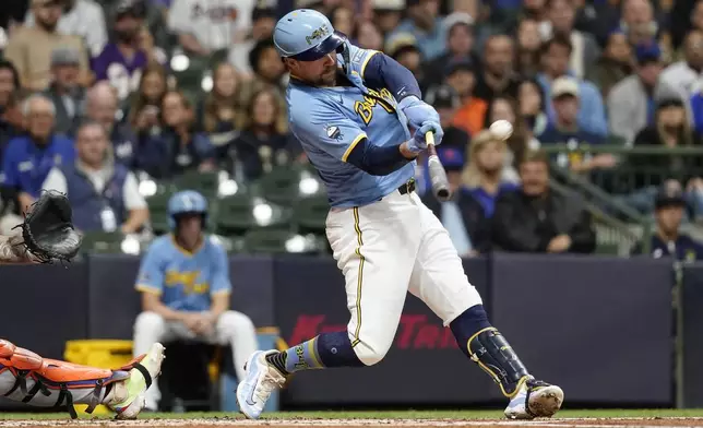 Milwaukee Brewers' Rhys Hoskins hits a grand slam during the first inning of a baseball game against the New York Mets, Friday, Sept. 27, 2024, in Milwaukee. (AP Photo/Aaron Gash)