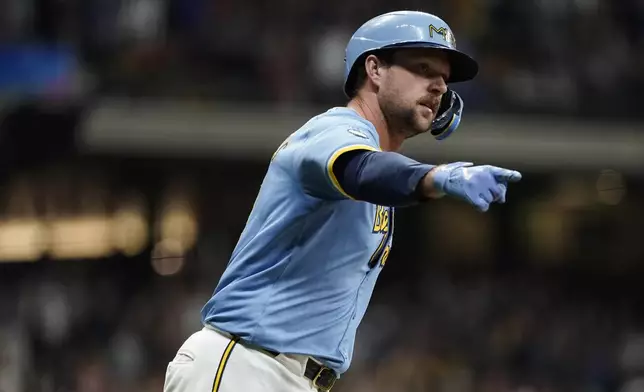 Milwaukee Brewers' Rhys Hoskins gestures after hitting a grand slam during the first inning of a baseball game against the New York Mets, Friday, Sept. 27, 2024, in Milwaukee. (AP Photo/Aaron Gash)