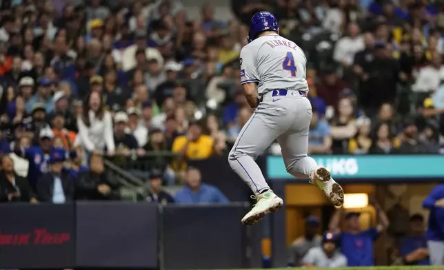 New York Mets' Francisco Alvarez (4) reacts after striking out during the fourth inning of a baseball game against the Milwaukee Brewers, Friday, Sept. 27, 2024, in Milwaukee. (AP Photo/Aaron Gash)