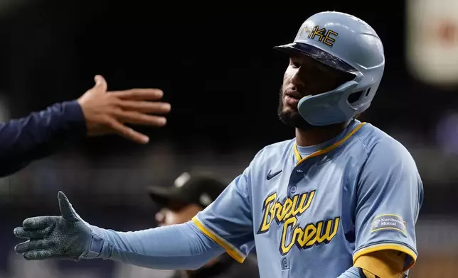 Milwaukee Brewers' Jackson Chourio is congratulated after hitting an RBI single during the fourth inning of a baseball game against the New York Mets, Friday, Sept. 27, 2024, in Milwaukee. (AP Photo/Aaron Gash)