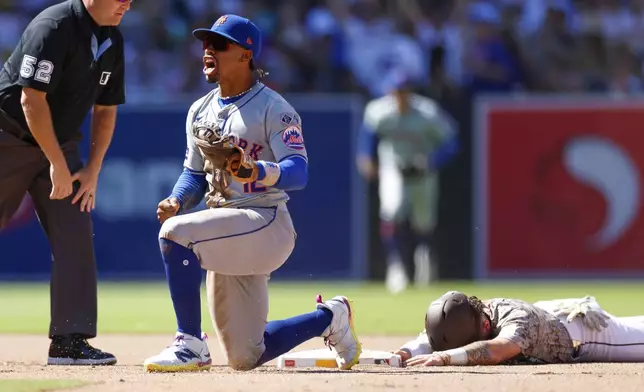 New York Mets shortstop Francisco Lindor reacts after applying a tag on San Diego Padres' Jackson Merrill for an out during a stolen base attempt in the seventh inning of a baseball game, Sunday, Aug. 25, 2024, in San Diego. (AP Photo/Brandon Sloter)