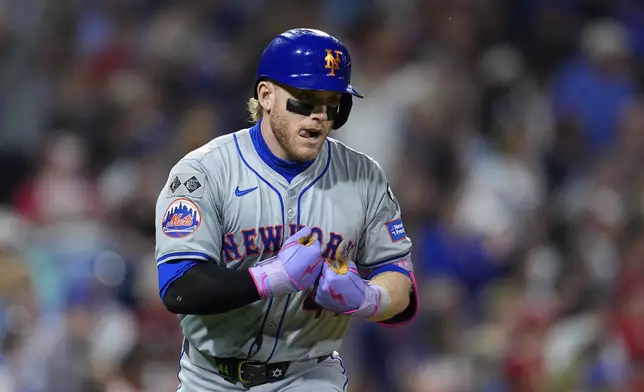 New York Mets' Harrison Bader reacts after hitting a three-run home run off Philadelphia Phillies' Tyler Gilbert during the eighth inning of a baseball game, Friday, Sept. 13, 2024, in Philadelphia. (AP Photo/Derik Hamilton)