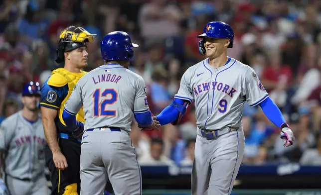 New York Mets' Brandon Nimmo (9) celebrates his three run home run off Philadelphia Phillies' Aaron Nola with Mets' Francisco Lindor (12) during the fifth inning of a baseball game, Friday, Sept. 13, 2024, in Philadelphia. (AP Photo/Derik Hamilton)