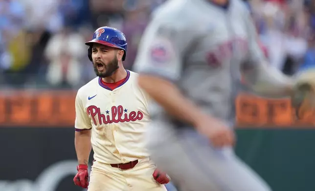 Philadelphia Phillies' Cal Stevenson reacts after hitting a two-run double off New York Mets' Reed Garrett during the seventh inning of a baseball game, Saturday, Sept. 14, 2024, in Philadelphia. (AP Photo/Derik Hamilton)