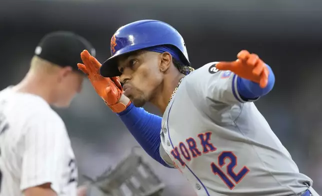 New York Mets' Francisco Lindor looks back at his teammates after his lead-off single during the third inning of a baseball game against the Chicago White Sox on Saturday, Aug. 31, 2024, in Chicago. (AP Photo/Charles Rex Arbogast)