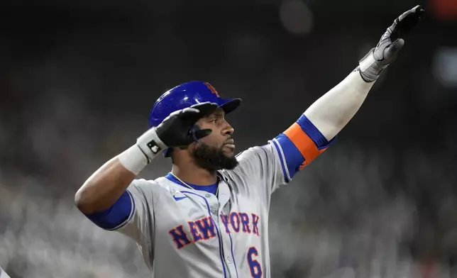 New York Mets' Starling Marte celebrates towards a large group of the team's fans in right field after his RBI single off Chicago White Sox relief pitcher Gus Varland in the sixth inning of a baseball game Saturday, Aug. 31, 2024, in Chicago. (AP Photo/Charles Rex Arbogast)