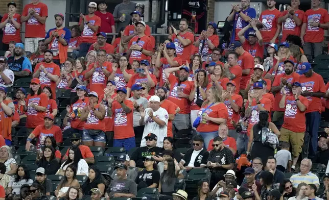 New York Mets fans occupy a large section of the right field bleachers at Guaranteed Rate Field during the fourth inning of a baseball game between the Chicago White Sox and the Mets Saturday, Aug. 31, 2024, in Chicago. (AP Photo/Charles Rex Arbogast)