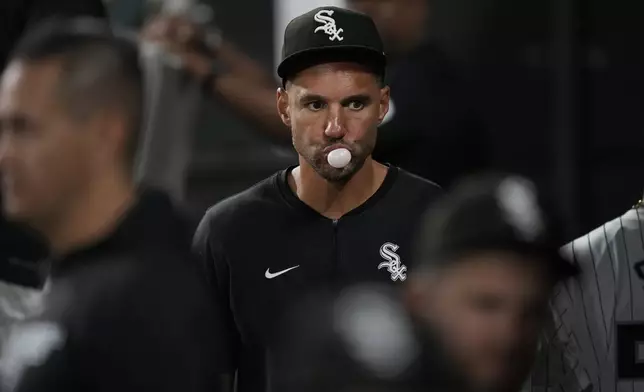 Chicago White Sox interim manager Grady Sizemore blows a bubble as he walks through the dugout during the ninth inning of a baseball game against the New York Mets on Saturday, Aug. 31, 2024, that saw the team tie the franchise season record of 106 losses in Chicago. (AP Photo/Charles Rex Arbogast)