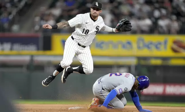 Chicago White Sox shortstop Jacob Amaya watches his throw to first after forcing New York Mets' Francisco Lindor out at second and getting Brandon Nimmo at first to turn the double play during the fifth inning of a baseball game Saturday, Aug. 31, 2024, in Chicago. (AP Photo/Charles Rex Arbogast)