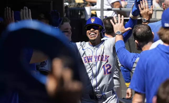 New York Mets' Francisco Lindor celebrates with teammates after hitting a solo home run during the fourth inning of a baseball game against the Chicago White Sox in Chicago, Sunday, Sept. 1, 2024. (AP Photo/Nam Y. Huh)