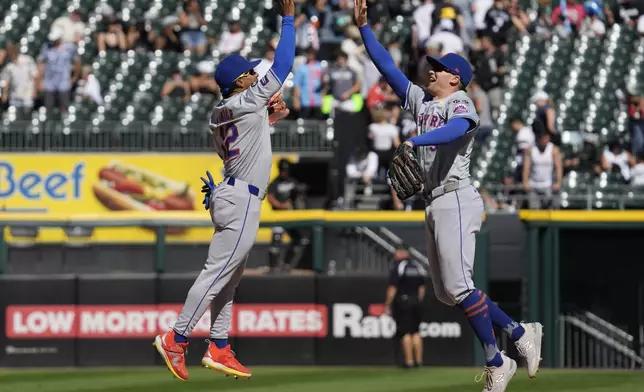 New York Mets' Francisco Lindor, left, celebrates with Brandon Nimmo, right, after they defeated the Chicago White Sox in a baseball game in Chicago, Sunday, Sept. 1, 2024. (AP Photo/Nam Y. Huh)