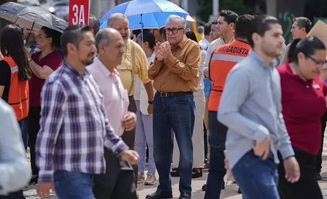 Sinaloa state Gov. Ruben Rocha, center, participates in an annual earthquake drill in Culiacan, Mexico, Thursday, Sept. 19, 2024. (AP Photo/Eduardo Verdugo)