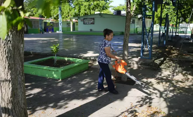 A person operates a leaf blower on the courtyard of the temporarily closed Lazaro Cardenas elementary school, in Culiacan, Sinaloa state, Mexico, Thursday, Sept. 19, 2024. (AP Photo/Eduardo Verdugo)