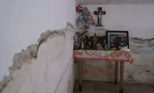 An altar stands in the home of Juana Salazar Segundo that was damaged by sewage-infused flooding in Valle de Chalco, State of Mexico, Thursday, Aug. 29, 2024. (AP Photo/Felix Marquez)