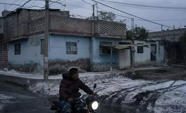 Lime covers a street to combat odor and humidity after sewage-infused flooding in Valle de Chalco, State of Mexico, Monday, Sept. 9, 2024. (AP Photo/Felix Marquez)