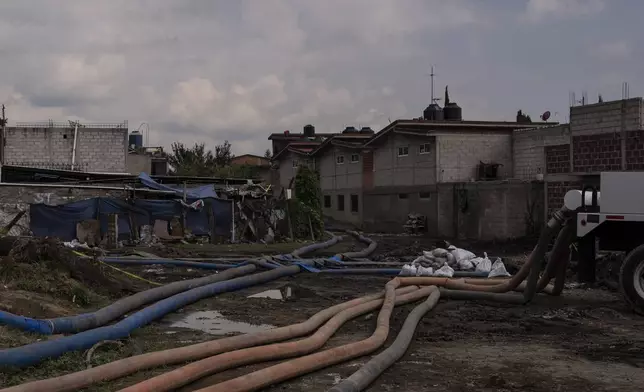 Sewage-infused floodwaters are pumped out of homes in Valle de Chalco, State of Mexico, Thursday, August 29, 2024. (AP Photo/Felix Marquez)