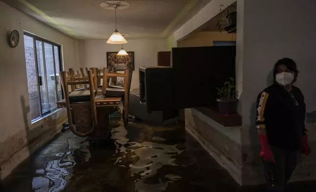 Rosa Daniel looks stands inside her house flooded by sewage-infused water in Valle de Chalco, State of Mexico, Thursday, Aug. 29, 2024. (AP Photo/Felix Marquez)