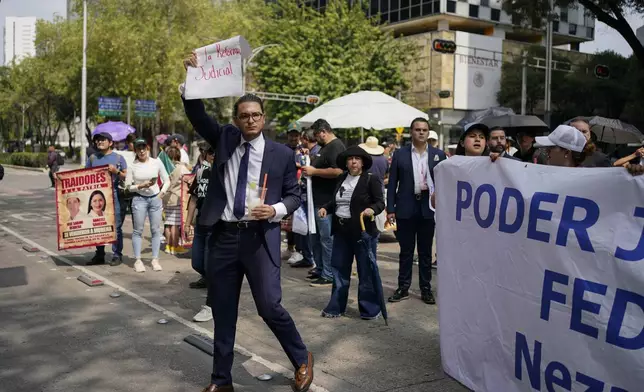 Law students protest the government's proposed judicial reform, which would require judges to get elected into office, in Mexico City, Wednesday, Sept. 4, 2024. (AP Photo/Felix Marquez)