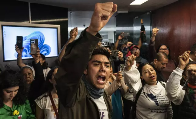 Protesters attempt to break into a room in the Senate as lawmakers weigh the government's proposed judicial reform, which would make judges stand for election, in Mexico City, Tuesday, Sept. 10, 2024. (AP Photo/Felix Marquez)