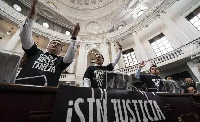 Mexico City legislators demonstrate against judicial reform, with signs that read in Spanish "No justice" at the Mexico City Congress, Thursday, Sept. 12, 2024. (AP Photo/Felix Marquez)