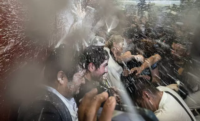 Protesters break into a Senate session in which lawmakers were debating the government's proposed judicial reform, which would make judges stand for election, in Mexico City, Tuesday, Sept. 10, 2024. (AP Photo/Felix Marquez)