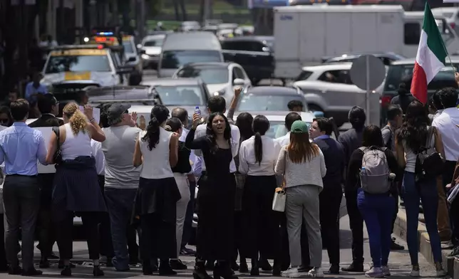 Law students block a street to protest against constitutional reform proposals that would make judges stand for election, outside a sports center where lawmakers are meeting as an alternative due to other demonstrators blocking Congress in Mexico City, Tuesday, Sept. 3, 2024. (AP Photo/Felix Marquez)