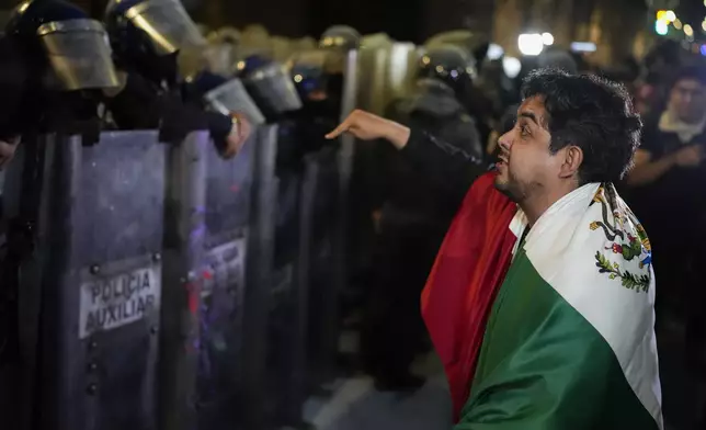 Judicial workers argue with the police during a protest the government's proposed judicial reform, which would make judges stand for election, outside the Senate in Mexico City, Tuesday, Sept. 10, 2024. (AP Photo/Eduardo Verdugo)