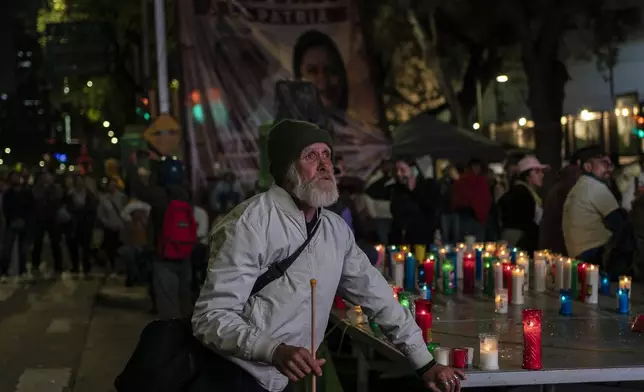 An elderly man watches on a large screen senators vote during a protest against government's proposed judicial reform, which would make judges stand for election, in Mexico City, Tuesday, Sept. 10, 2024. (AP Photo/Felix Marquez)