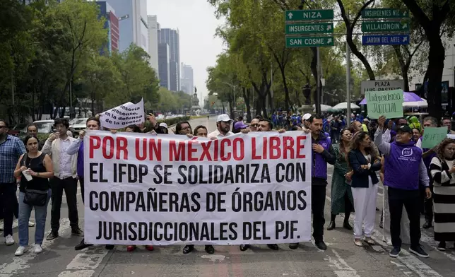 Federal court workers block the road in front of the Senate to protest the government's proposed judicial reform in Mexico City, Wednesday, Sept. 4, 2024. (AP Photo/Felix Marquez)